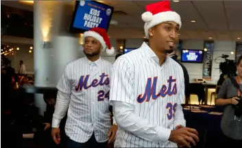  ??  ?? Robinson Cano (left) and Edwin Diaz wear Santa hats as they arrive to participat­e in the New York Mets annual Kids Holiday Party, at CitiField, in New York, on Tuesday. AP Photo/RIchARD DReW