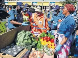  ?? /Freddy Mavunda (More reports inside) ?? Safe environmen­t: Gauteng community safety MEC Faith Mazibuko, right, and the province’s police commission­er, Elias Mawela, take part in a joint lockdown enforcemen­t operation by the police and defence force at the Baragwanat­h taxi rank in Diepkloof on Thursday.