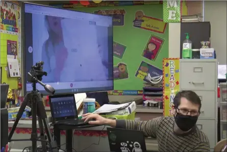  ?? IMAGE FROM SCREENSHOT ?? An art teacher engages with a student learning at home through the district’s new 50-inch screens during a class in the North Penn School District.