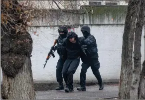  ?? (AP/Vasily Krestyanin­ov) ?? Armed riot police officers detain a protester during a security anti-terrorist operation in a street after clashes Saturday in Almaty, Kazakhstan. Video at arkansason­line.com/19kazakh/.