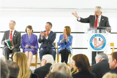  ??  ?? Dick Grosboil, president of the Suicide Deterrent Advisory Committee, with Sen. Dianne Feinstein and Rep. Nancy Pelosi onstage, speaks during the ceremony at the Golden Gate Bridge Welcome Center Plaza.