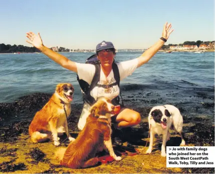  ??  ?? > Jo with family dogs who joined her on the South West CoastPath Walk, Toby, Tilly and Jess