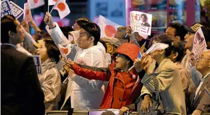  ?? —AFP ?? Supporters of Prime Minister Shinzo Abe celebrate his victory in the lower house elections.