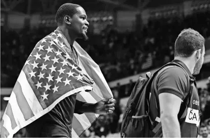  ?? BOB ROSATO, RVR PHOTOS/USA TODAY SPORTS ?? Kevin Durant, who scored 30 points in the finale, celebrates Team USA’s 96-66 victory against Serbia for the Americans’ third consecutiv­e men’s basketball gold.