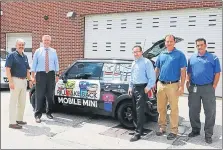  ??  ?? Montgomery County District Attorney Kevin R. Steele, second from the left, is joined by Pennsylvan­ia American Water officials to unveil the addition to his Drug Take Back program. The “Pill Take Back Mobile MINI” visits community events.