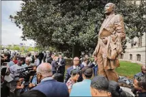  ?? BOB ANDRES /BANDRES@AJC.COM ?? Rep. Calvin Smyre (hand on statue) played a role in getting a statue of the Rev. Martin Luther King Jr. placed on the grounds of the State Capitol. The statue was unveiled this summer on the anniversar­y of King’s famed “I Have a Dream” speech.