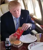  ??  ?? Fast food: Trump enjoys a burger