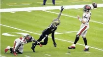  ?? TYLER KAUFMAN/AP ?? Tampa Bay Buccaneers quarterbac­k Tom Brady throws the ball over New Orleans Saints safety Malcolm Jenkins on Sunday.