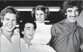  ?? AP FILE ?? “Star Wars” cast members Harrison Ford (Han Solo), Anthony Daniels (C-3PO), Carrie Fisher (Princess Leia) and Peter Mayhew (Chewbacca) gather in Los Angeles in 1978, a year after the release of the original movie.