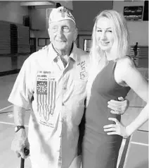  ?? COURTESY PHOTO ?? Pearl Harbor survivor John Seelie poses for a photo with University of Miami architectu­re student Emi Kopke.