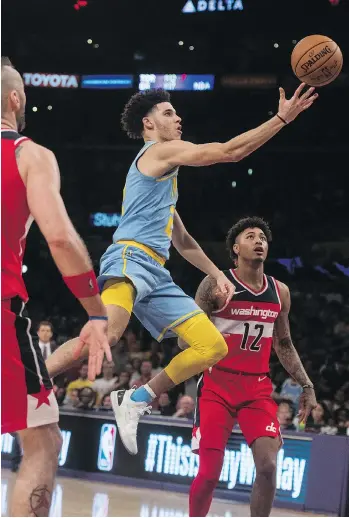  ?? KYUSUNG GONG/THE ASSOCIATED PRESS ?? Los Angeles Lakers rookie guard Lonzo Ball, centre, has played only five NBA games, but has been in the media spotlight since being drafted No. 2 overall by the Lakers this summer.