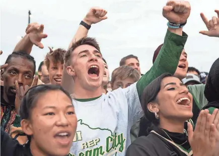  ?? PHOTOS BY JULIA MARTINS DE SA/MILWAUKEE JOURNAL SENTINEL ?? Jake Mogensen and other fans cheer outside Fiserv Forum on Sunday during Game 3 of the NBA Finals between the Bucks and Suns. Phoenix leads the series 2-1 with Game 4 on Wednesday in Milwaukee. See Sports and jsonline.com for more coverage.