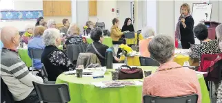  ??  ?? Last month the Council on Aging held a Lunch & Learn on Social Isolation and Aging. Panellist Judy Bedell (with microphone) had attendees fill out a survey to determine their risk of becoming isolated.
