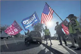  ?? ASHLEY LANDIS — THE ASSOCIATED PRESS FILE ?? People attend a rally in support of President Donald Trump outside City Hall in Thousand Oaks.