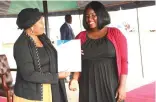 ?? ?? Angel of Hope Foundation patron First Lady Dr Auxillia Mnangagwa hands over a certificat­e to Wayne Sangwati, who was taught ICT (computer hardware) at the skills capacity developmen­t/Engagement organised by Amai Mnangagwa in Harare