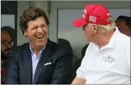  ?? AP PHOTO/SETH WENIG, FILE ?? Tucker Carlson, left, and former President Donald Trump, right, react during the final round of the Bedminster Invitation­al LIV Golf tournament in Bedminster, N.J., July 31, 2022.