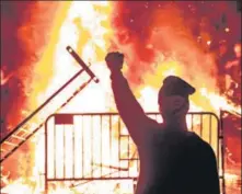  ??  ?? ■
A protester near a fire during a rally outside the White House in Washington, DC.