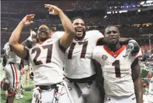  ?? Curtis Compton / Atlanta Journal-Constituti­on /TNS ?? Seniors Nick Chubb (27), Isaiah Wynn (77) and Sony Michel celebrate Georgia’s win over Auburn in the SEC title game.