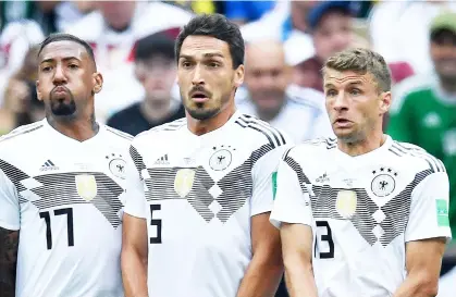  ?? — AFP photo ?? (From left) Germany’s Jerome Boateng, Mats Hummels and Thomas Mueller line up to make a wall during the Russia 2018 World Cup Group F match between Germany and Mexico at the Luzhniki Stadium in Moscow file photo.