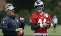  ?? MATT ROURKE — THE ASSOCIATED PRESS ?? In this Aug. 21 file photo, Philadelph­ia Eagles quarterbac­k Carson Wentz and coach Doug Pederson talk during practice at the team’s NFL football training facility in Philadelph­ia. Wentz is one of several key players who missed Philadelph­ia’s playoff run and are returning from injuries.