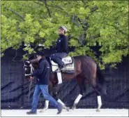  ?? GARRY JONES — THE ASSOCIATED PRESS ?? Kentucky Derby winner Always Dreaming, ridden by exercise rider Nick Bush, walks at Pimlico Race Course in Baltimore Monday.