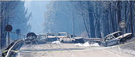  ??  ?? Burnt out cars and body bags strewn across a rural road, with the death toll now thought to be ‘rising towards 100’