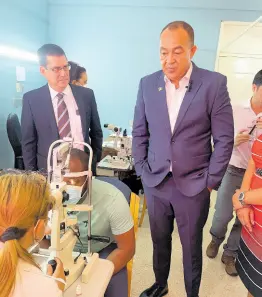  ?? ANDRE WILLIAMS PHOTO ?? Cuban Ambassador to Jamaica, Fermin Gabriel Quinones Sanchez, and Dr Christophe­r Tufton, minister of health and wellness, watch as a patient is being examined at the centre on Tuesday.