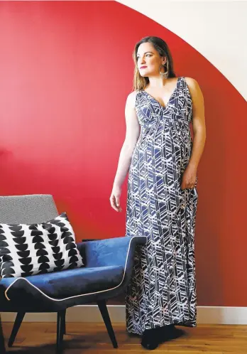  ?? GARY REYES/STAFF ?? Rena Ramirez wears a blue printed maternity maxi-dress she acquired from rental fashion company Le Tote at her office in San Francisco. Ramirez rents clothing on a subscripti­on basis from Le Tote to supplement her wardrobe.