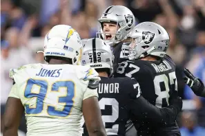  ?? AP Photo/Ellen Schmidt ?? ■ Las Vegas Raiders kicker Daniel Carlson, center, celebrates Sunday after kicking the game-winning field goal against the Los Angeles Chargers during overtime of an NFL football game in Las Vegas.