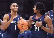  ?? Jessica Hill / Associated Press ?? UConn’s Rahsool Diggins, left, and Corey Floyd, Jr. smile during the Huskies’ First Night celebratio­n on Oct. 15 in Storrs.