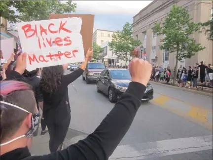  ?? DAN SOKIL - MEDIANEWS GROUP ?? A protester holds a poster reading “Black lives matter” during a peaceful protest on Main Street in Lansdale on Tuesday, June 2.