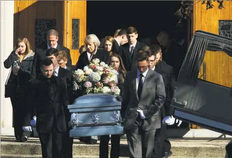  ?? Christian Abraham / Hearst Connecticu­t Media ?? Family and friends leave a funeral service for Melanie Coleman at St. Mary’s Church in Milford on Saturday. Coleman, a 20yearold Southern Connecticu­t State University gymnast, died last week after a training accident.
