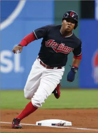  ?? RON SCHWANE — THE ASSOCIATED PRESS ?? Jose Ramirez rounds third base on the way to scoring on a single by Edwin Encarnacio­n during the first inning of a regular-season game against the Twins at Progressiv­e Field.