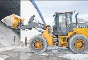  ?? DAVID JALA/CAPE BRETON POST ?? CBRM public works heavy equipment operator James Broussard uses a loader to dig into a giant pile of salt at the department’s central Sydney depot. Municipal crews report that all equipment is ready and that the CBRM is prepared for its annual battle...