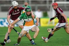  ?? SPORTSFILE ?? Boxed in: Tom Spain of Offaly holds off Joe Canning (left) and Conor Whelan on Saturday