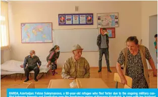  ??  ?? BARDA, Azerbaijan: Fatma Suleymanov­a, a 80-year-old refugee who fled Terter due to the ongoing military conflict between Armenia and Azerbaijan over the breakaway region of Nagorno-Karabakh, is seen with her husband in a classroom of a secondary school on Monday. — AFP