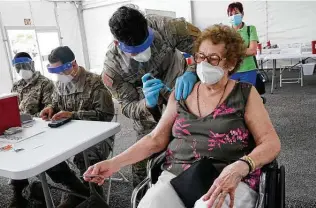  ?? Marta Lavandier / Associated Press ?? Loida Mendez, 86, gets a dose of the Pfizer COVID-19 vaccine Wednesday in North Miami, Fla. An untold number of older people are getting left behind in the desperate dash for shots.