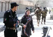  ?? - Reuters ?? DISTRAUGHT: An Afghan woman seeks for her relative at the site of a suicide in Kabul, Afghanista­n March 21, 2018.