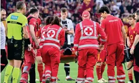  ?? ?? Evan Ndicka is carried off on a stretcher after collapsing in the match against Udinese. Roma later said their defender was ‘in good spirits’ in hospital. Photograph: Xinhua/Shuttersto­ck