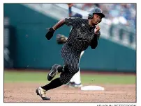  ?? AP/JOHN PETTERSON ?? Harrison Ray advances to third base for Vanderbilt after a Michigan error in the fifth inning of Tuesday night’s game at Omaha, Neb.