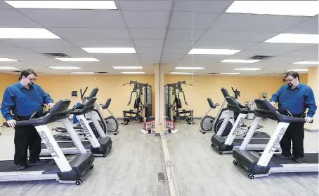  ?? DAN JANISSE ?? Ron Dunn, executive director of the Downtown Mission, checks out equipment in the new fitness facility at the organizati­on’s Ouellette Avenue location on Tuesday. “It’s all about teaching people to refocus and maybe even reset,” Dunn says.