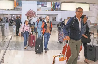  ?? ANNE-MARIE CARUSO/NORTHJERSE­Y.COM ?? Passengers, including some who were on a flight from Israel, arrive at Newark Airport on Friday. Some told of difficulti­es finding a way out of the besieged area and back to the U.S.