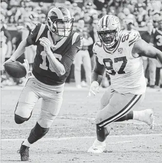  ?? BRIAN VAN DER BRUG LOS ANGELES TIMES ?? Rams QB Jared Goff is chased out of the pocket by Green Bay Packers’ Kenny Clark on Sunday at the Coliseum in Los Angeles. The Rams remained the only unbeaten team in the NFL this season with a 29-27 victory.