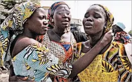  ?? OLAMIKAN GBEMIGA/AP ?? Relatives embrace one of the girls released by Boko Haram on Saturday in Abuja, Nigeria.