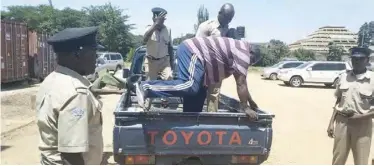  ??  ?? Kambwili disembarks from a police vehicle at the Magistrate’s Court yesterday.