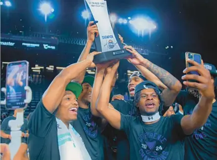  ?? KARL MERTON FERRON/STAFF PHOTOS ?? The Lincoln men’s basketball team hoists the trophy after winning the CIAA Tournament championsh­ip against Fayettevil­le State at CFG Bank Arena in Baltimore.