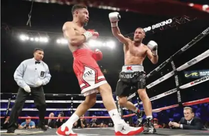  ?? —AFP ?? LAS VEGAS: Andre Ward (L) and Sergey Kovalev battle it out during their light heavyweigh­t championsh­ip bout at the Mandalay Bay Events Center on Saturday in Las Vegas, Nevada. Ward retained his WBA/IBF/WBO titles with a TKO in the eighth round.