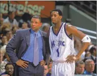  ?? Andy Lyons Getty Images ?? DOC RIVERS helped Tracy McGrady become a superstar in Orlando during his early years as a head coach.