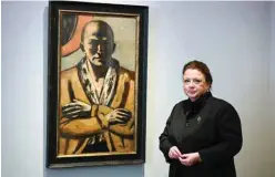  ?? — AFP ?? Micaela Kapitzky, director and partner of Berlin’s Grisebach auction house, poses next to the painting “Selbstbild­nis gelb-rosa” (Self-Portrait Yellow-Pink) by German painter Max Beckmann (1884-1950) in Berlin.