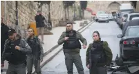  ?? (Yonatan Sindel/Flash90) ?? BORDER POLICE at the scene of a stabbing attack near Lions Gate in Jerusalem’s Old City yesterday.